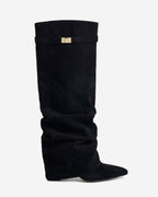 Women's black slouchy knee-high boots with pointed toes and buckle strap details