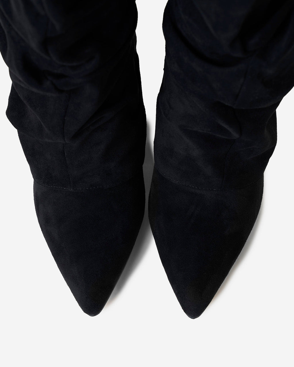 Women's black slouchy knee-high boots with pointed toes and buckle strap details