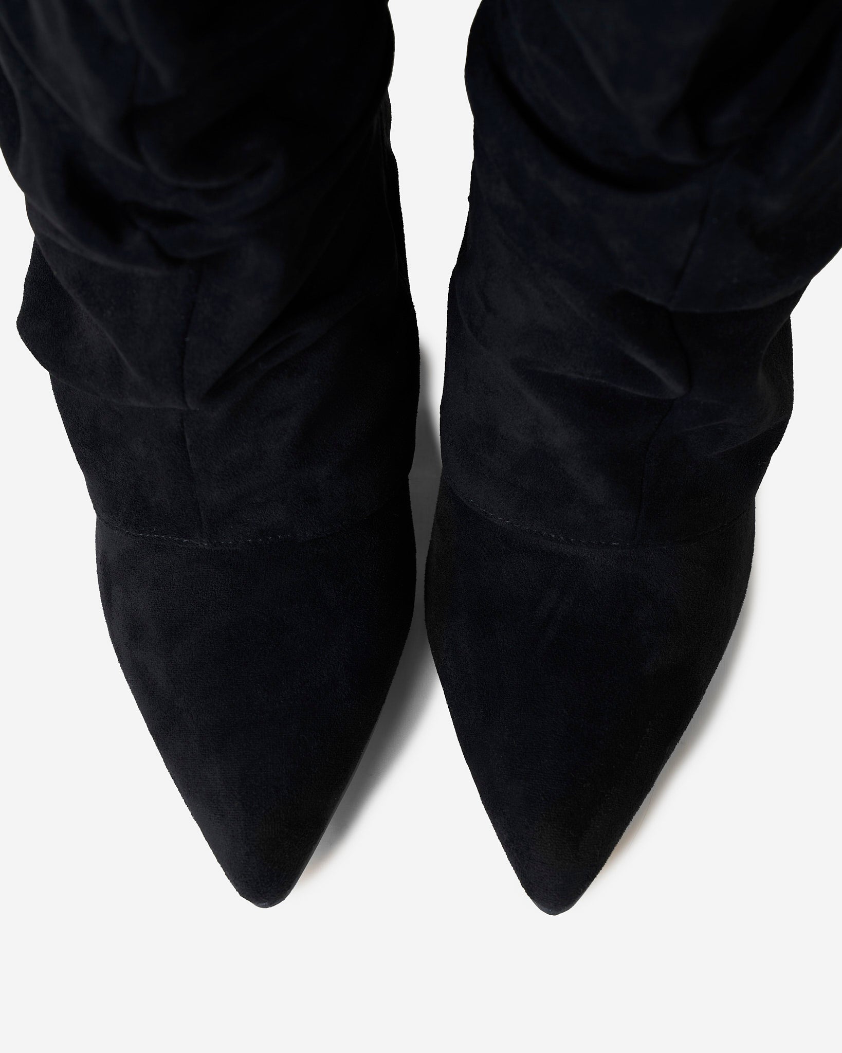 Women's black slouchy knee-high boots with pointed toes and buckle strap details