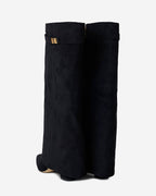 Women's black knee-high boots with pointed toes, low heels and buckle strap details