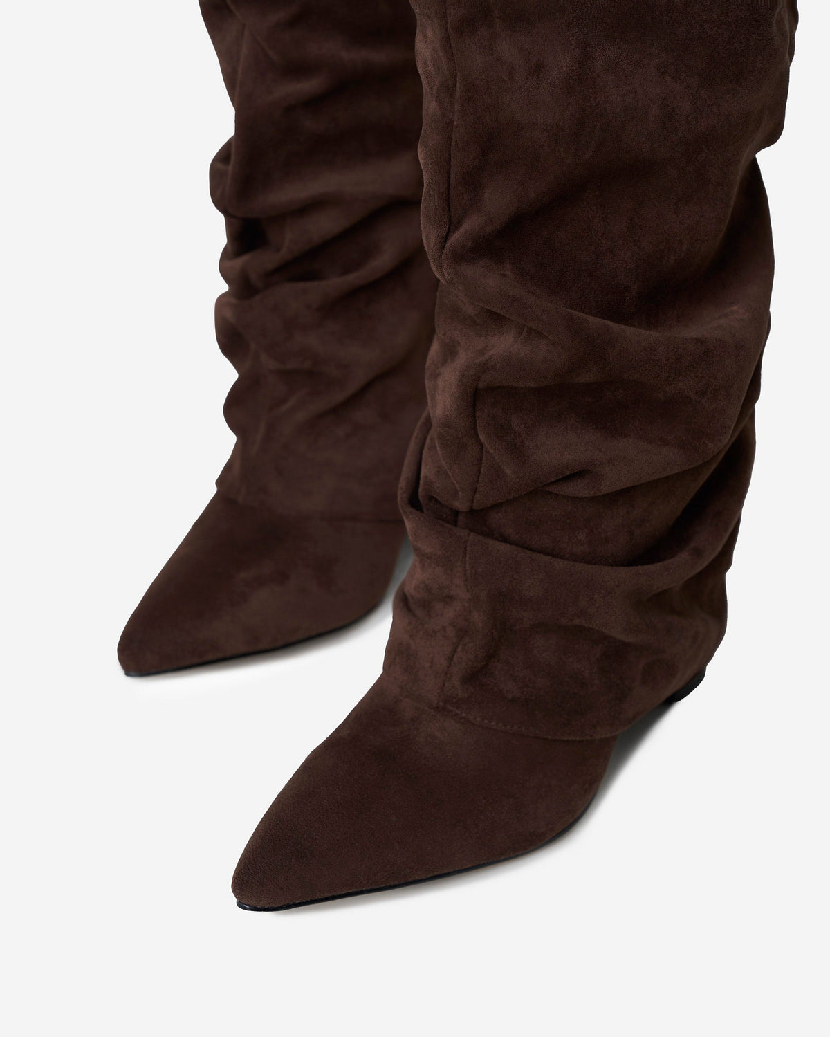 Women's brown slouchy knee-high boots with pointed toes, low heels and buckle straps