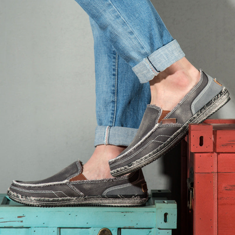Casual slip-on loafers with rounded toes, stitched uppers and flat textured soles