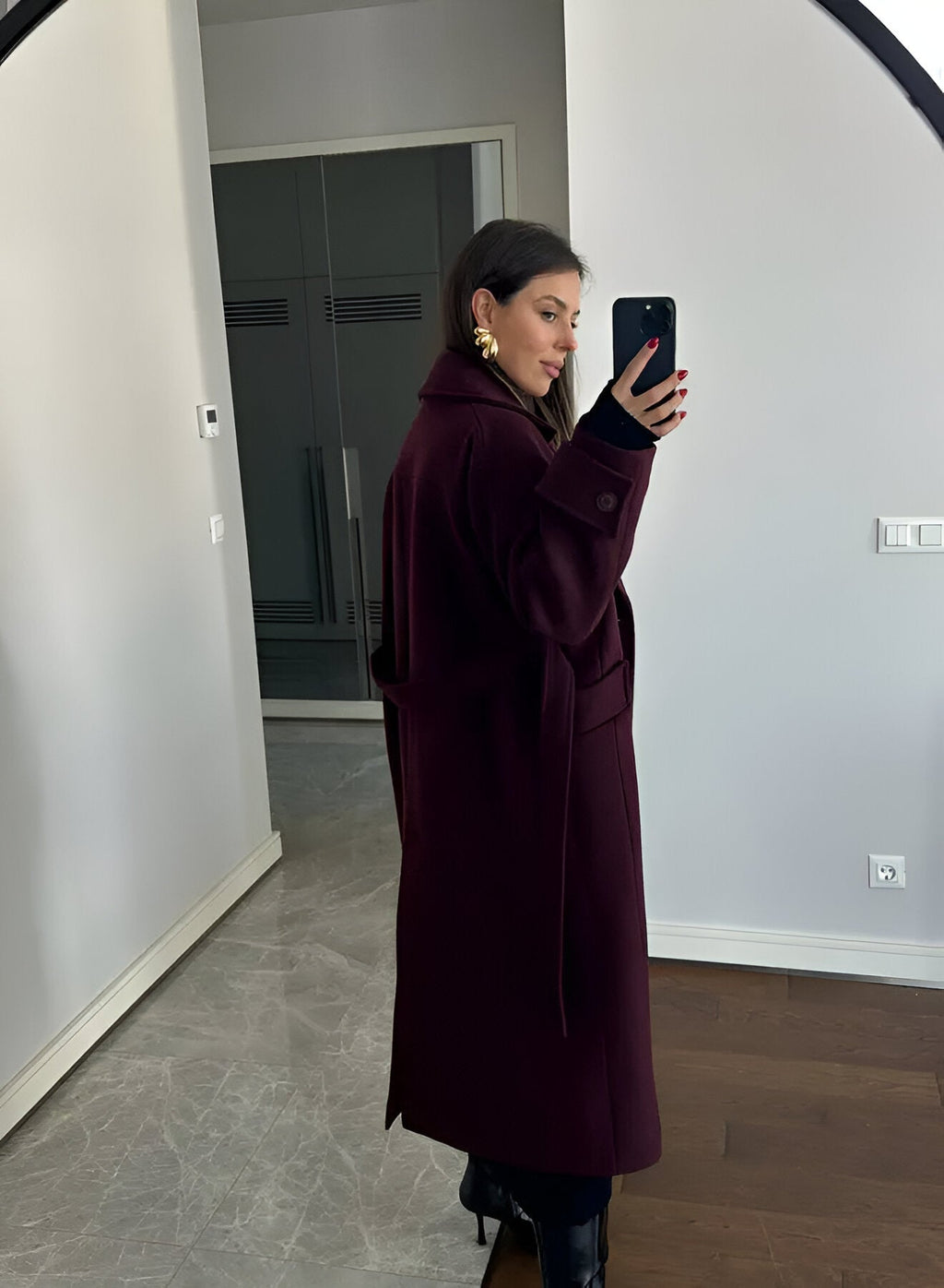 Women's burgundy long belted trench coat with double-breasted buttons and lapels