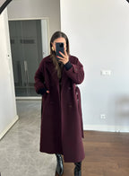 Women's burgundy long belted trench coat with double-breasted buttons and lapels