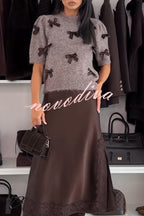 Women's taupe knitted crop top with dark bow details and short sleeves