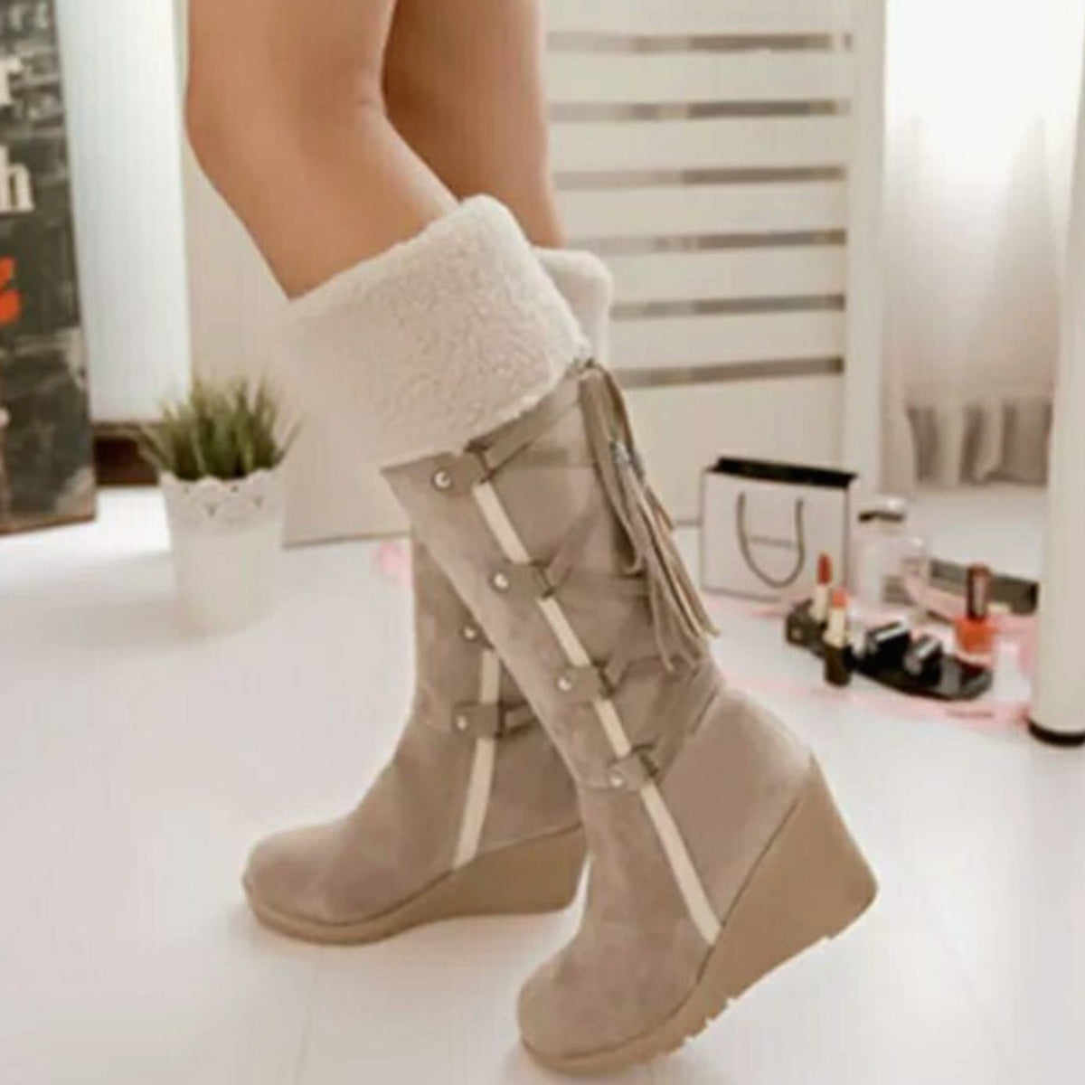 Women's knee-high wedge boots with textured trim, buckle straps and tassel detail
