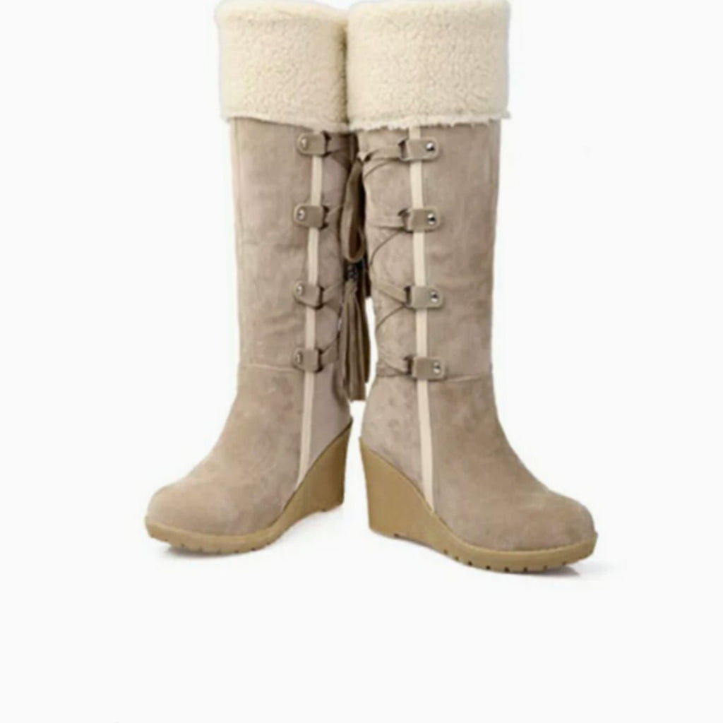 Women's knee-high wedge boots with textured trim, buckle straps and tassel detail