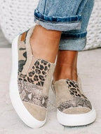 Women's patterned slip-on loafers with animal-print panels and flat white soles