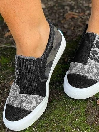 Women's patterned slip-on loafers with animal-print panels and flat white soles
