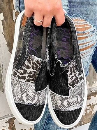 Women's patterned slip-on loafers with animal-print panels and flat white soles