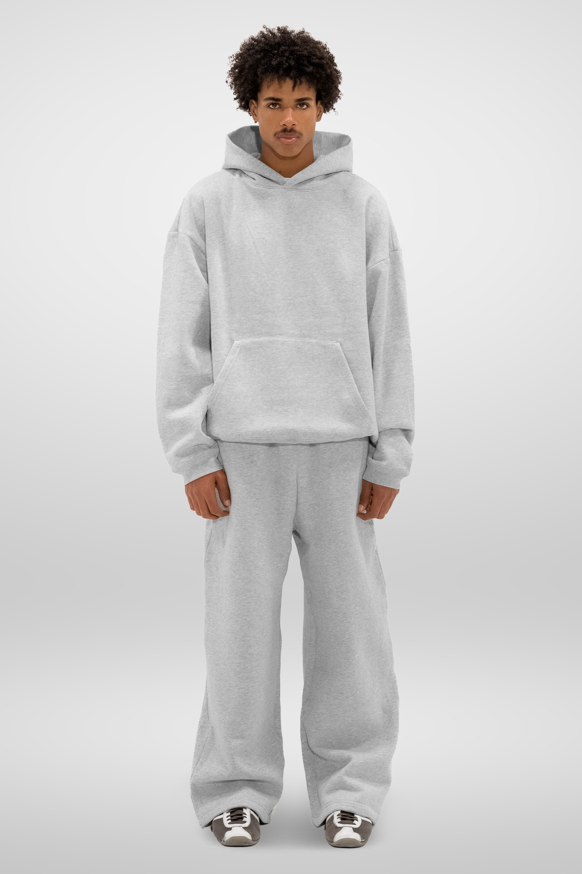 Men's grey wide-leg fleece sweatpants shown with trainers