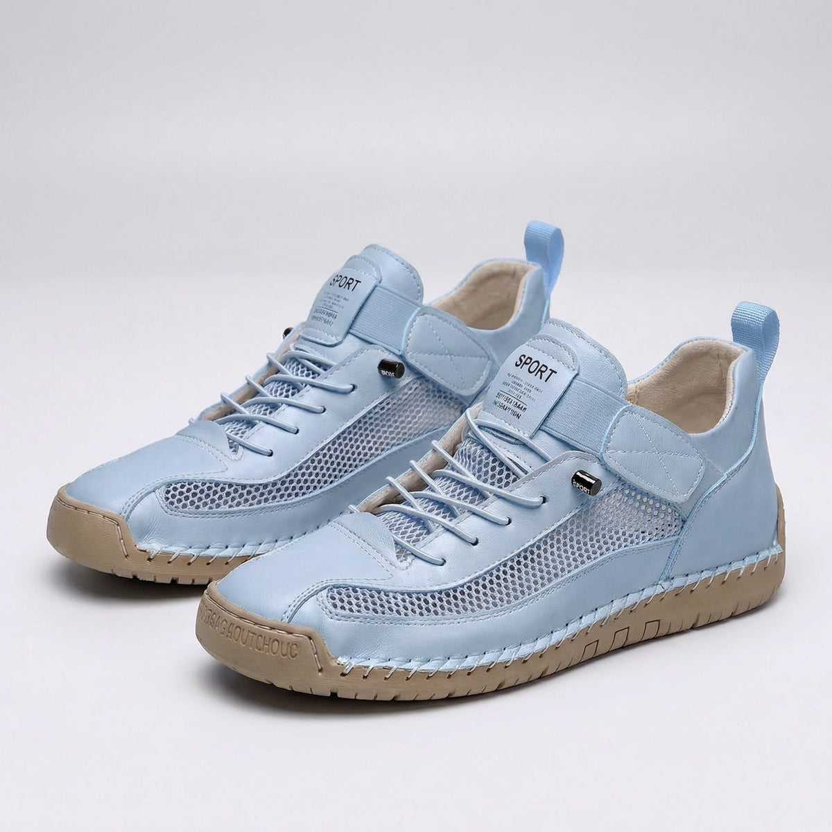 Women's lace-up trainers with mesh side panels, rounded toe and flat textured sole