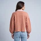 Women's cropped utility jacket with long sleeves, chest pockets and frayed trims
