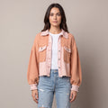 Women's cropped utility jacket with long sleeves, chest pockets and frayed trims