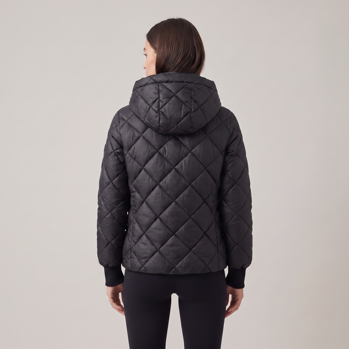 Women's oversized quilted hooded puffer jacket with long sleeves and zip front