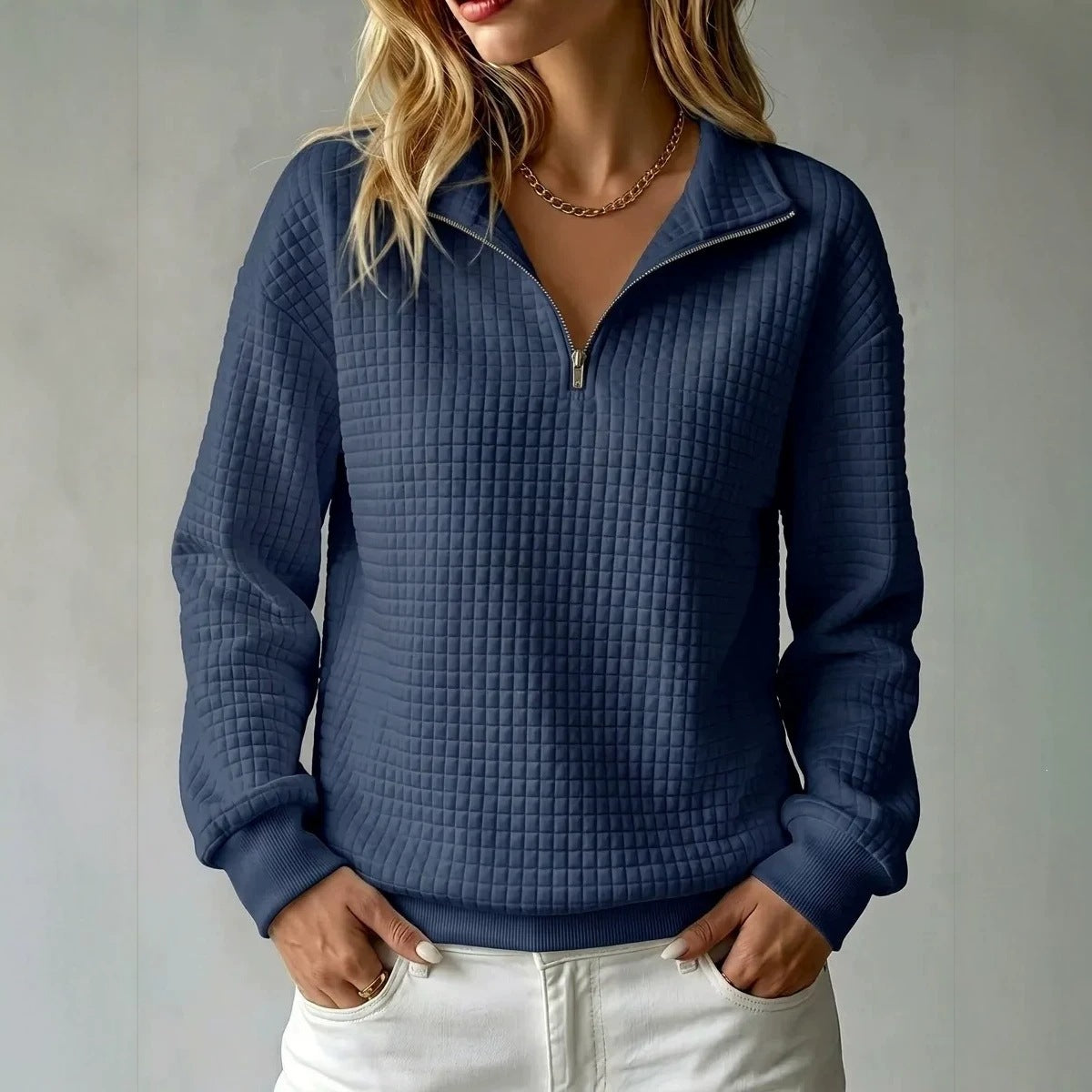 Women's quilted half-zip sweatshirt with raised collar and long sleeves