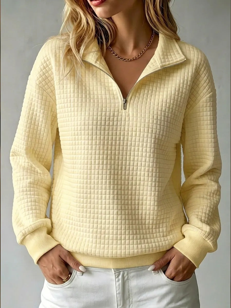 Women's quilted half-zip sweatshirt with raised collar and long sleeves