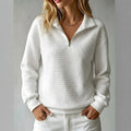 Women's quilted half-zip sweatshirt with raised collar and long sleeves