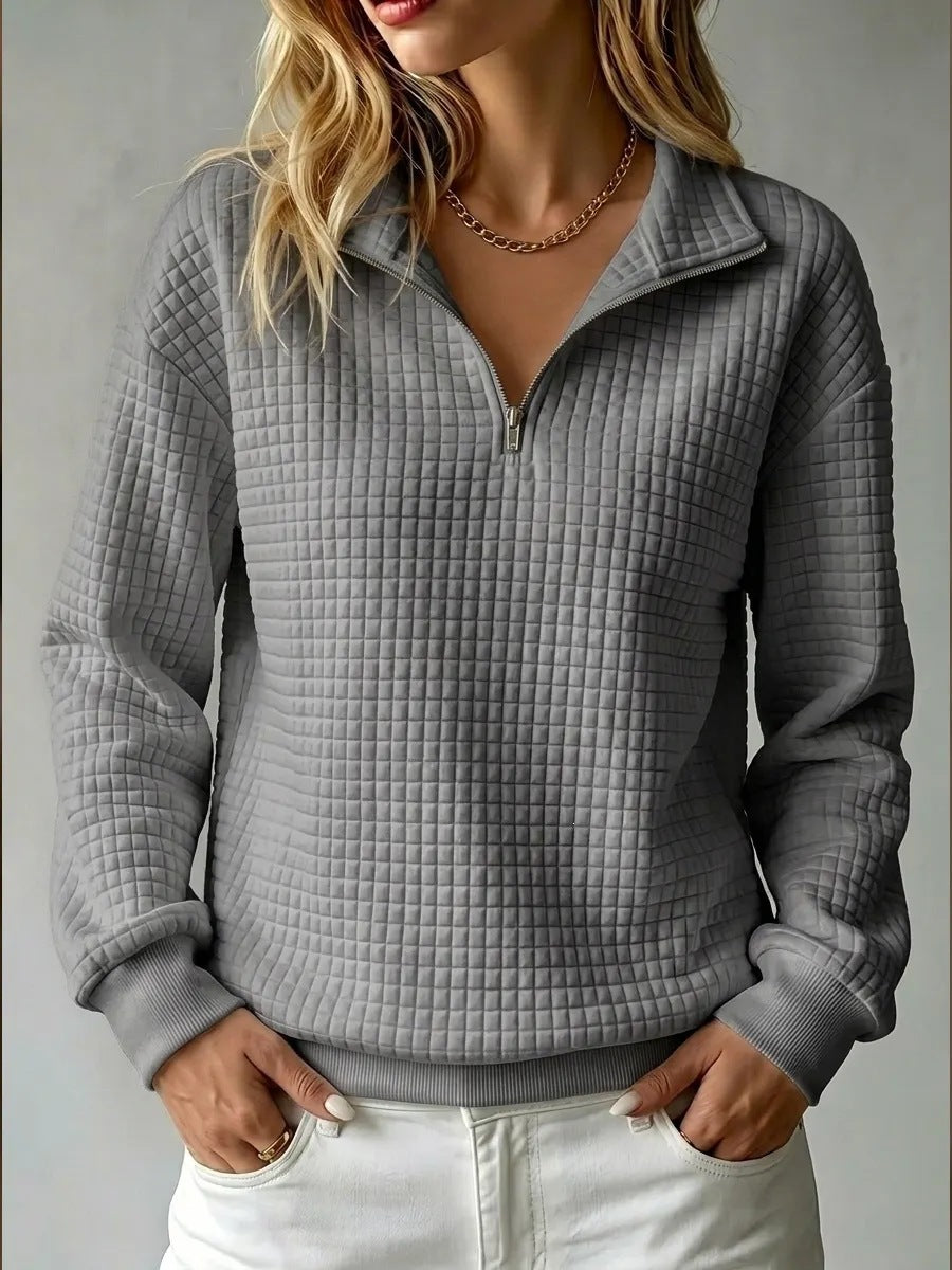 Women's quilted half-zip sweatshirt with raised collar and long sleeves