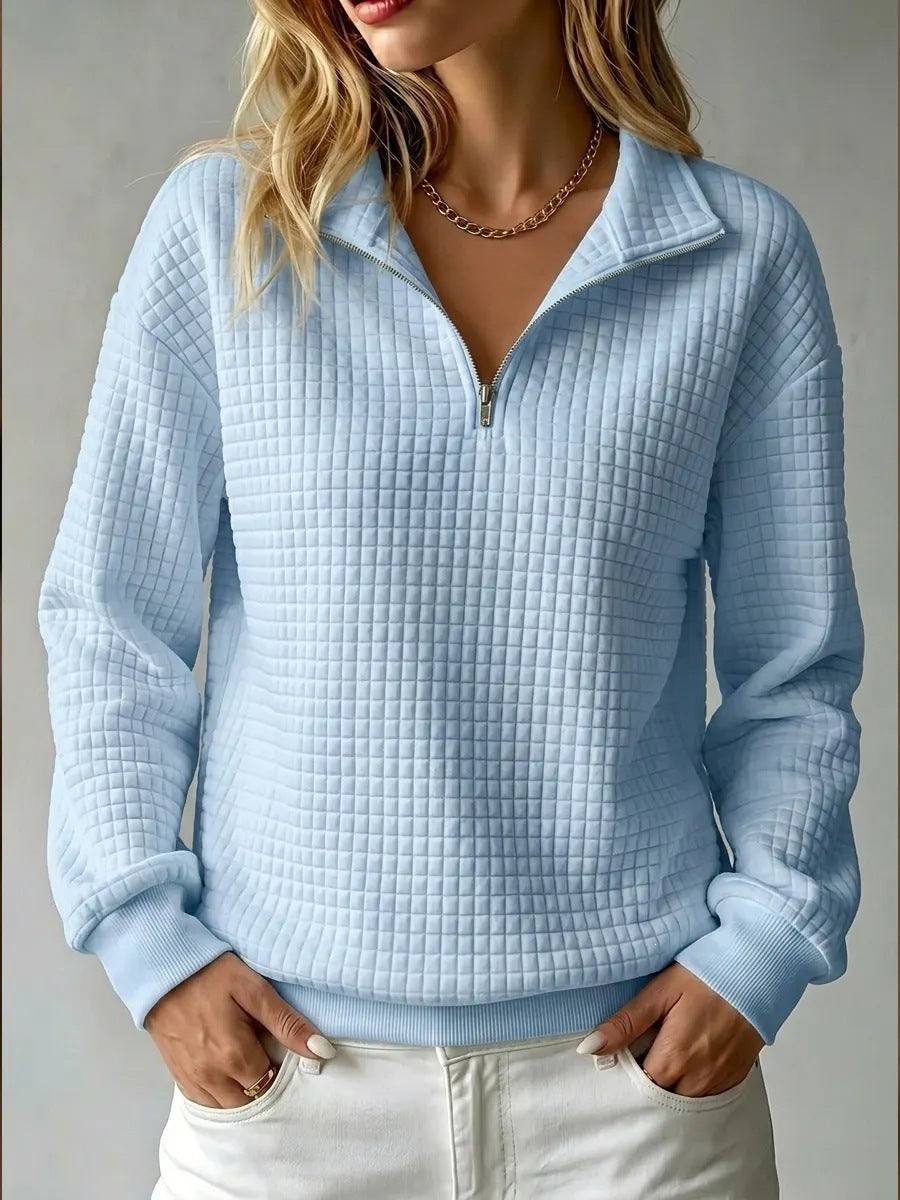Women's quilted half-zip sweatshirt with raised collar and long sleeves