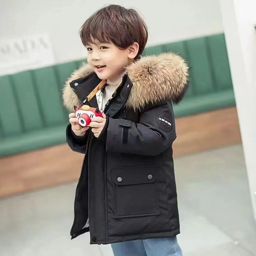 Child wearing a long hooded winter parka with fur-style hood trim and front pockets