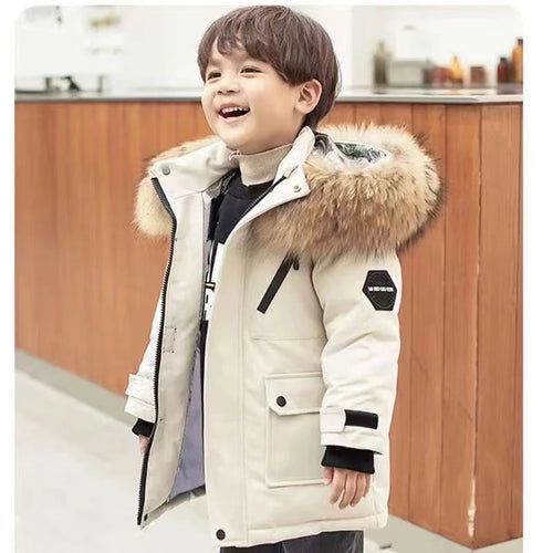 Child wearing a long hooded winter parka with fur-style hood trim and front pockets