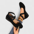 Women's strappy wedge shoes with Mary Jane-inspired cross straps and almond toe