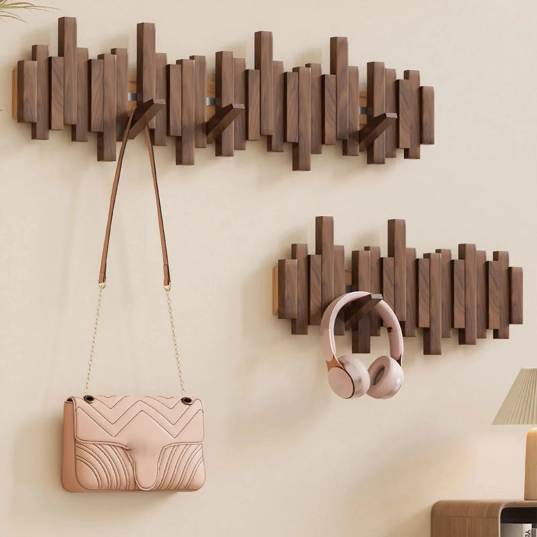 Wall-mounted slatted wooden coat rack with multiple hooks, umbrella and coat