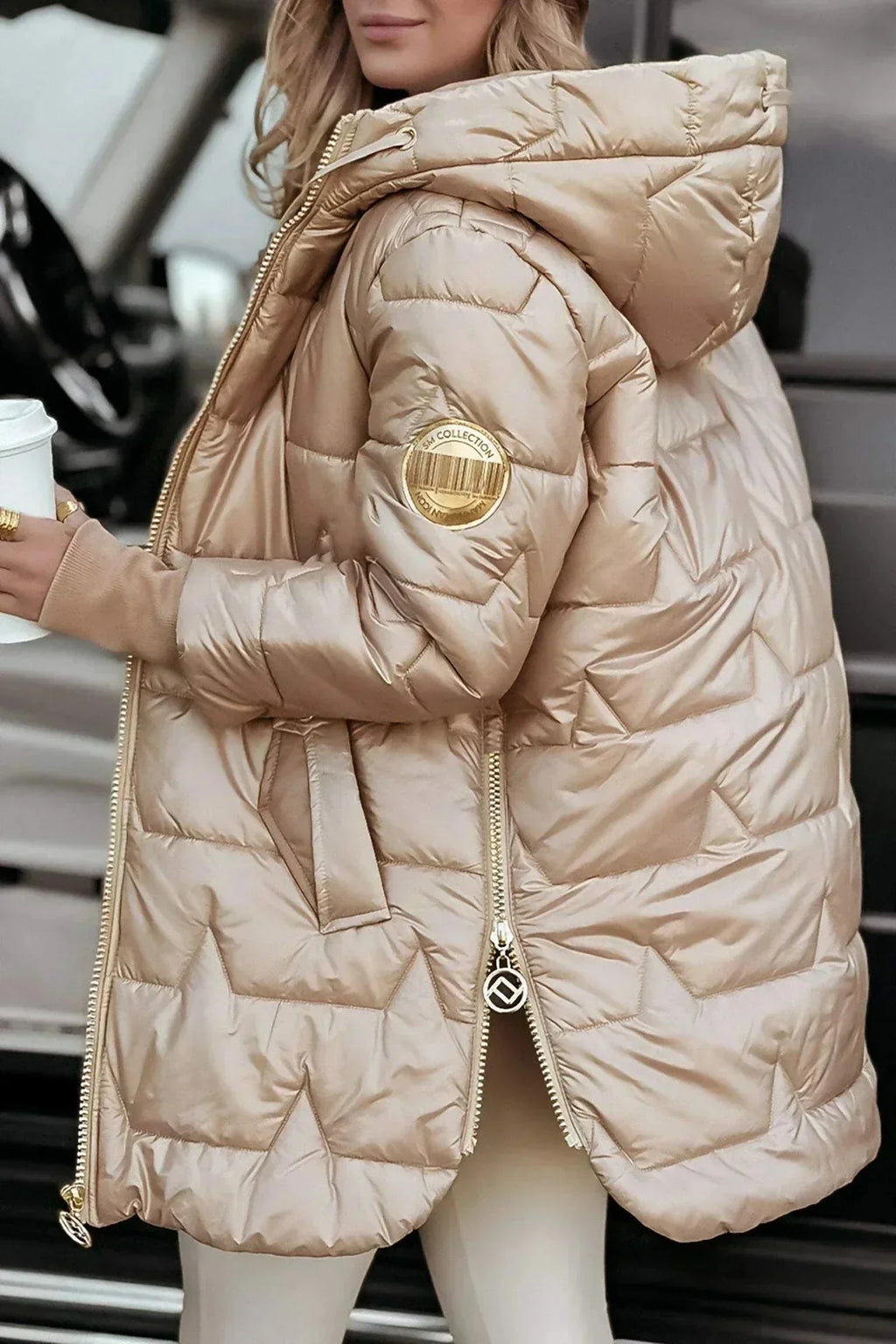 Women's longline hooded quilted winter jacket with zip front and ribbed cuffs