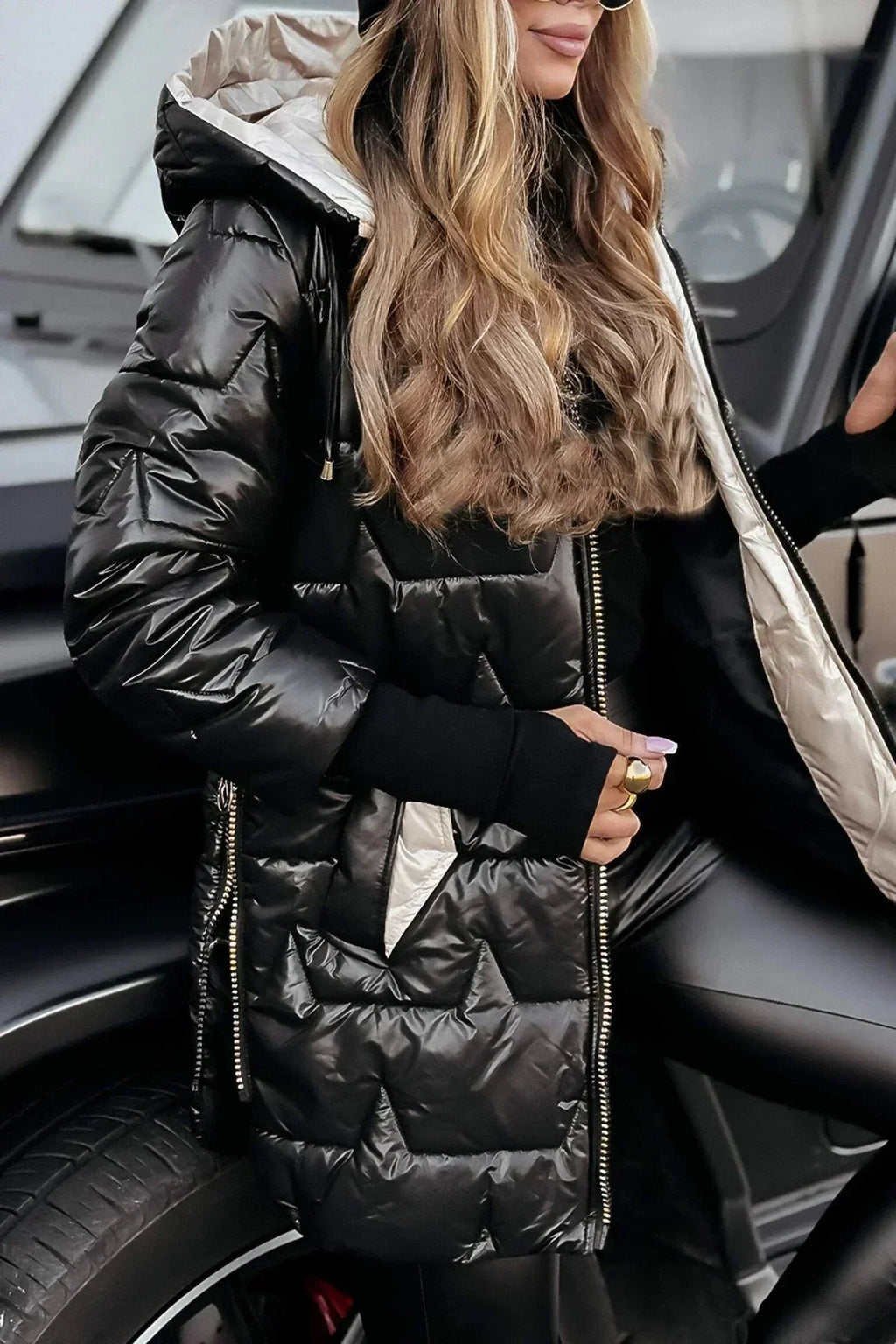 Women's longline hooded quilted winter jacket with zip front and ribbed cuffs