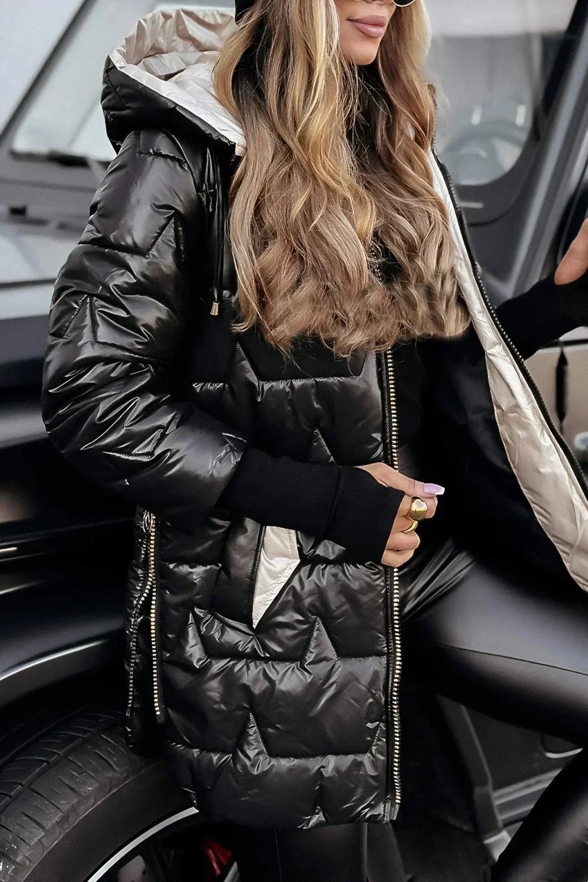 Women's longline hooded quilted winter jacket with zip front and ribbed cuffs
