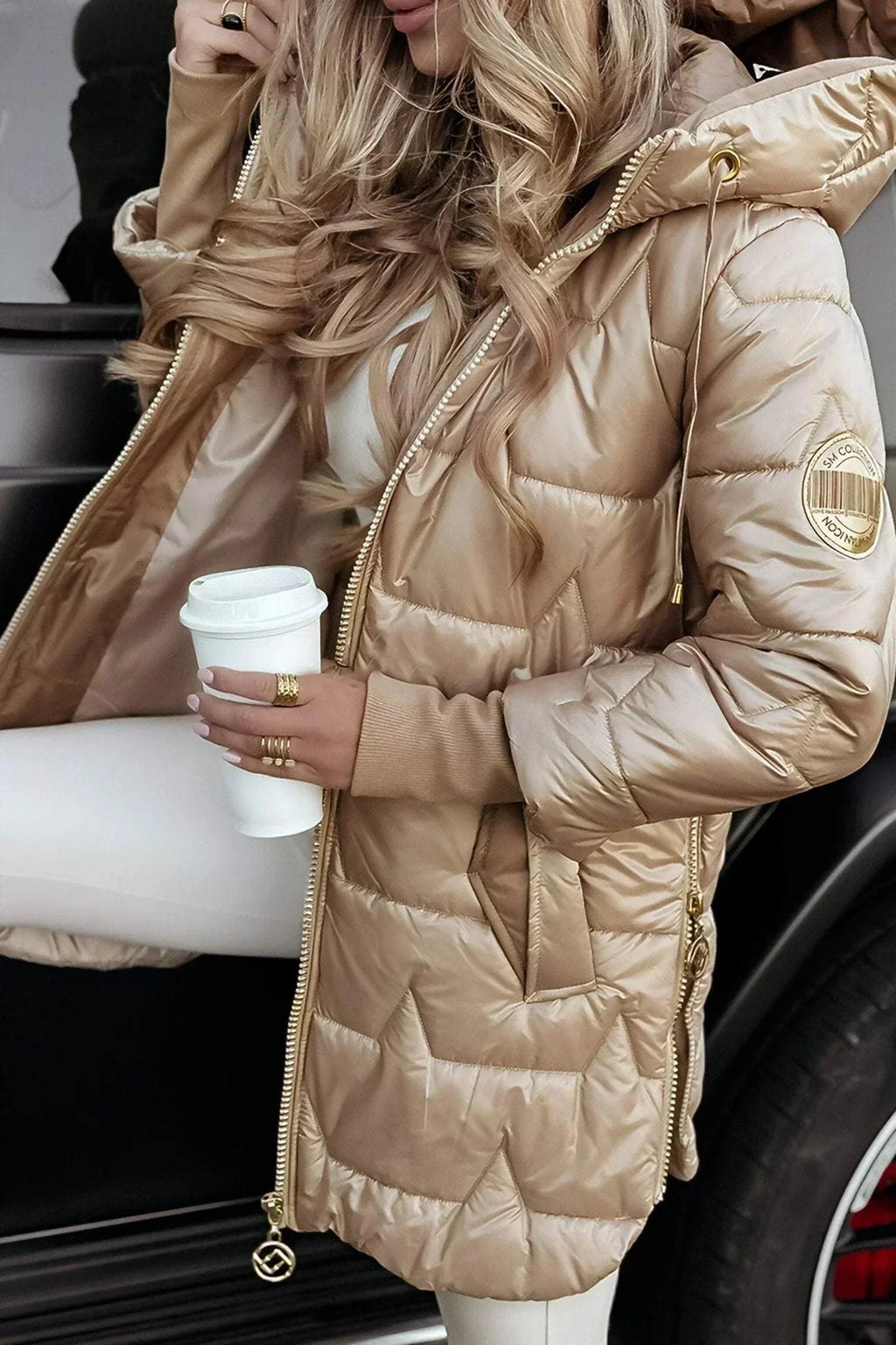 Women's longline hooded quilted winter jacket with zip front and ribbed cuffs
