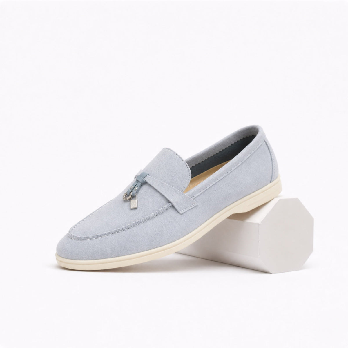 Women's classic slip-on loafer with rounded toe, flat sole and decorative metal trim