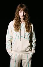 Cream hoodie with turquoise outlined star motifs, drawstring hood and front kangaroo pocket