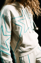 Cream hoodie with turquoise outlined star motifs, drawstring hood and front kangaroo pocket