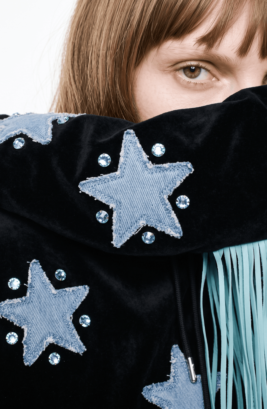 Black hooded hoodie with blue star appliques and turquoise fringe trim