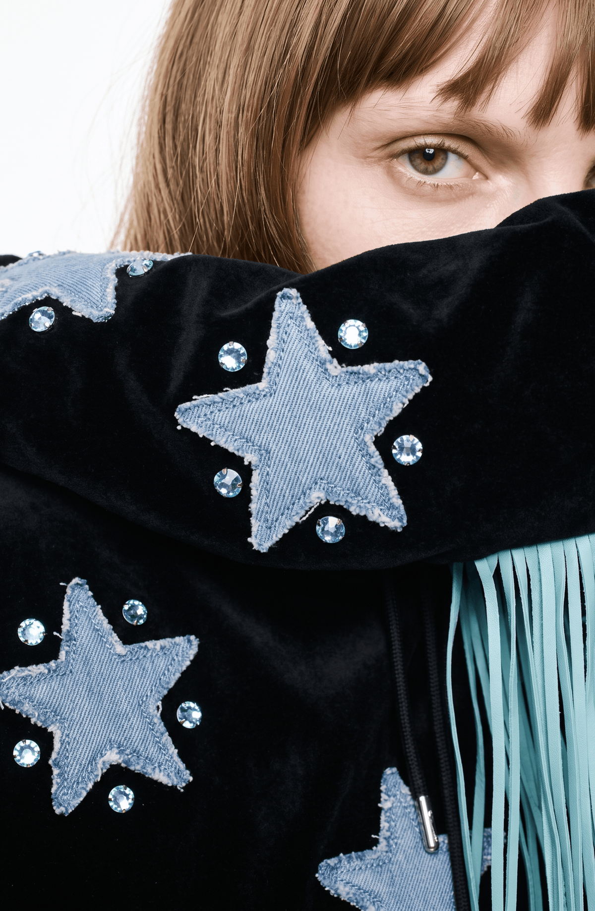 Black hooded hoodie with blue star appliques and turquoise fringe trim