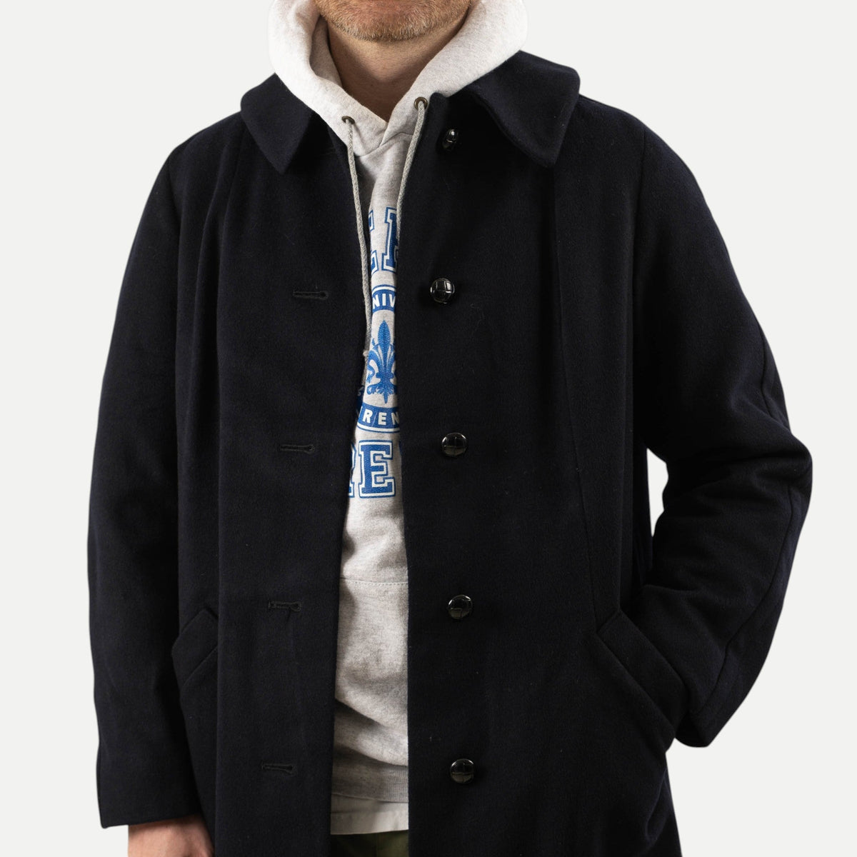 Men's navy overcoat with long sleeves, notched collar and button front