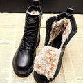 Black women's lace-up ankle boots with beige fur-look lining and treaded soles