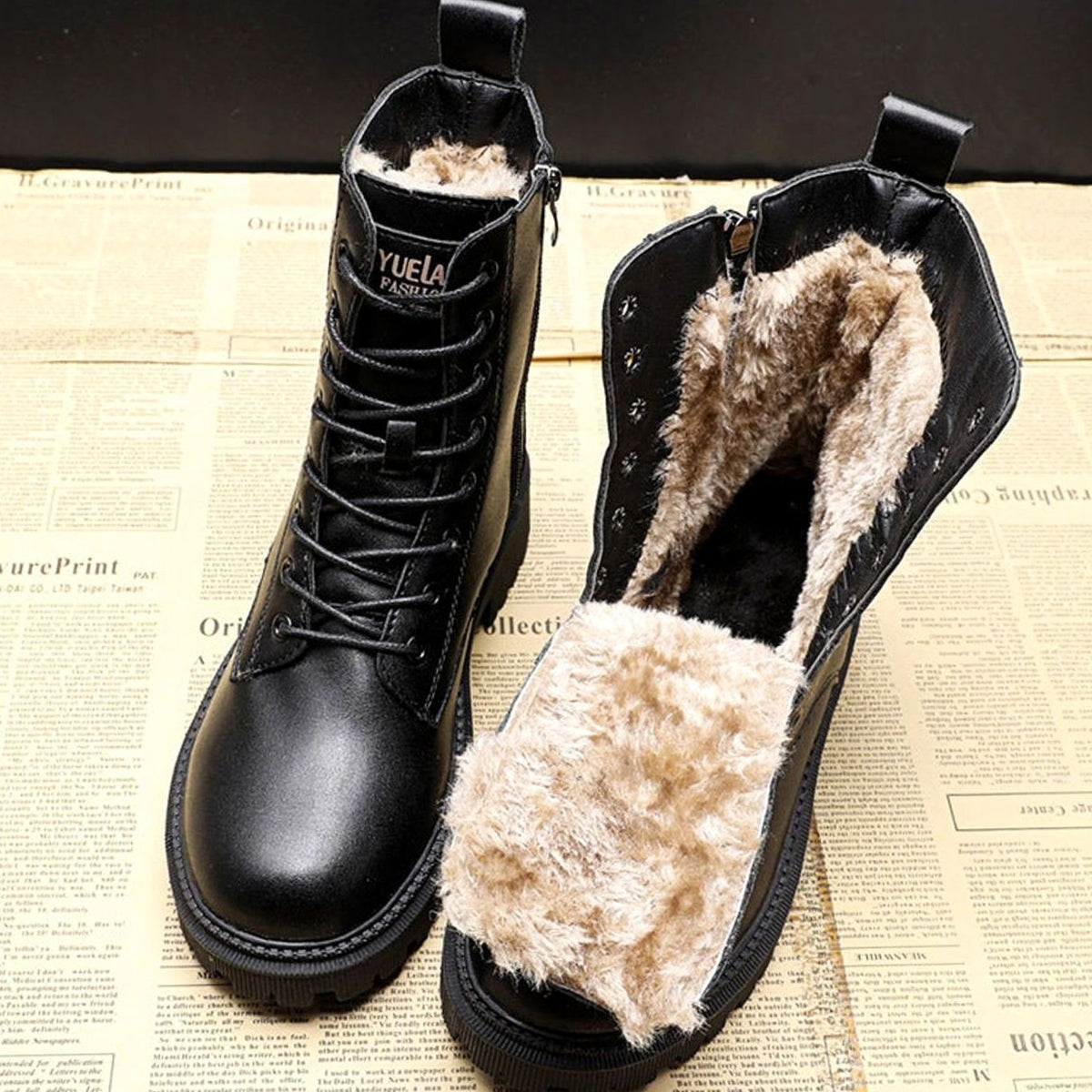 Black women's lace-up ankle boots with beige fur-look lining and treaded soles