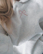 Women's light grey hooded sweatshirt with pink embroidery and floral-lined hood