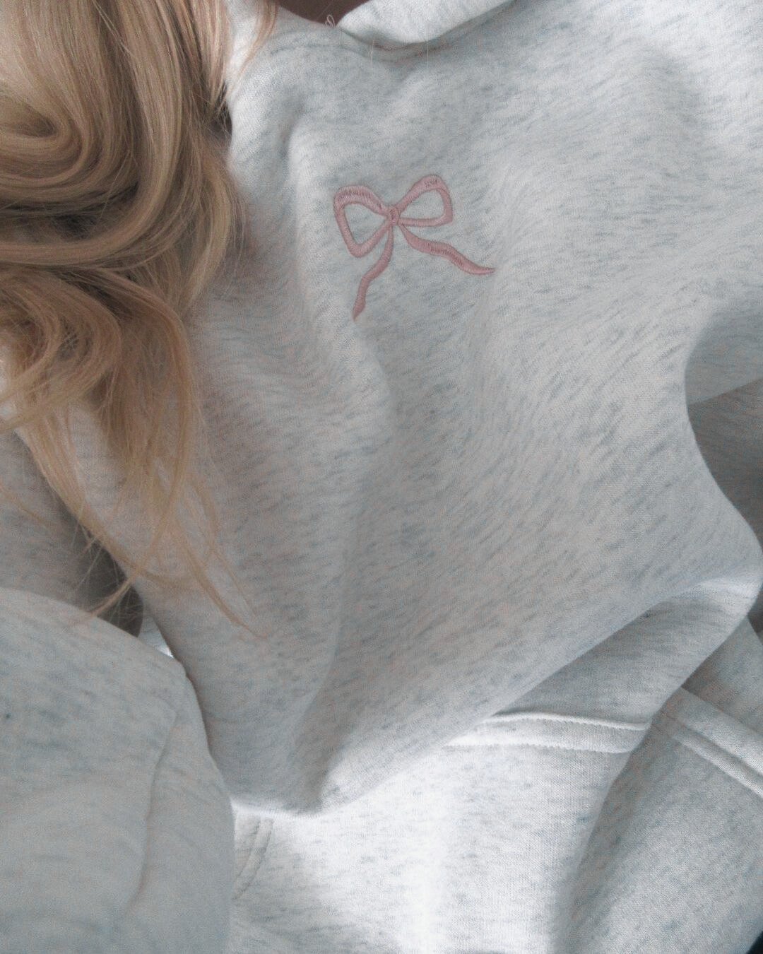 Women's light grey hooded sweatshirt with pink embroidery and floral-lined hood