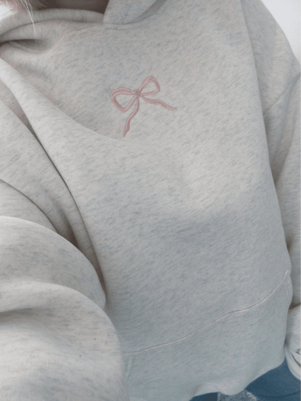 Women's light grey hooded sweatshirt with pink embroidery and floral-lined hood