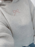 Women's light grey hooded sweatshirt with pink embroidery and floral-lined hood