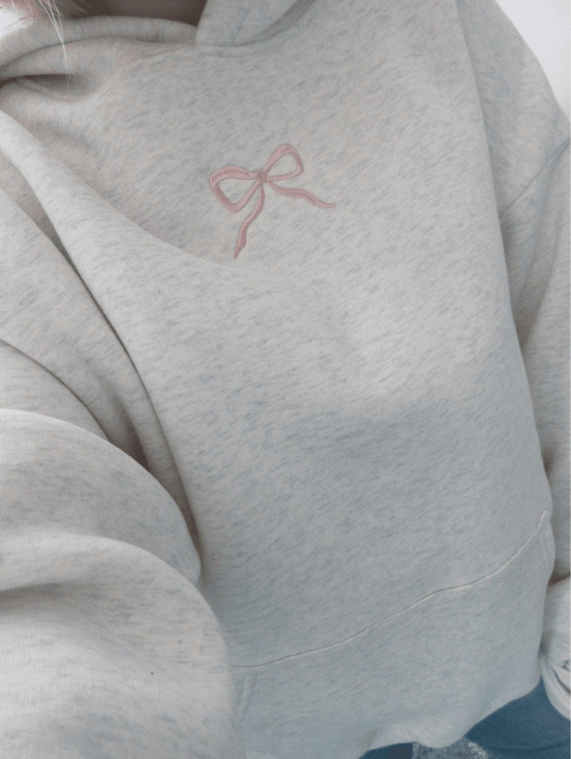 Women's light grey hooded sweatshirt with pink embroidery and floral-lined hood
