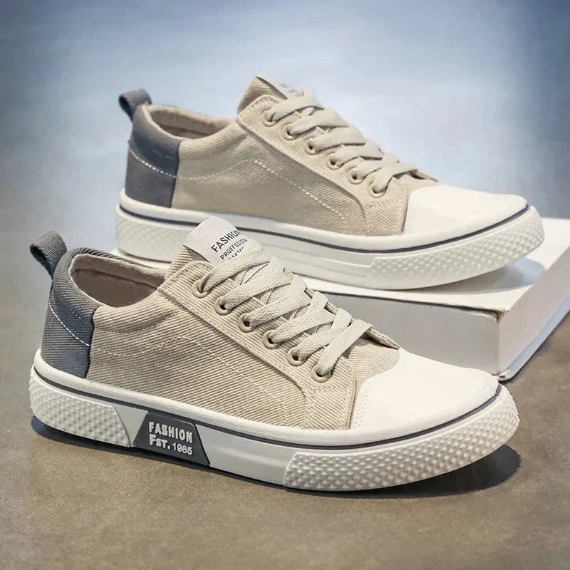 Low-top lace-up trainers shown in blue and green colourways with round toes and contrast soles