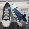 Low-top lace-up trainers shown in blue and green colourways with round toes and contrast soles
