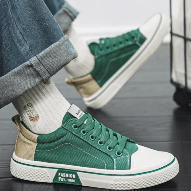 Low-top lace-up trainers shown in blue and green colourways with round toes and contrast soles