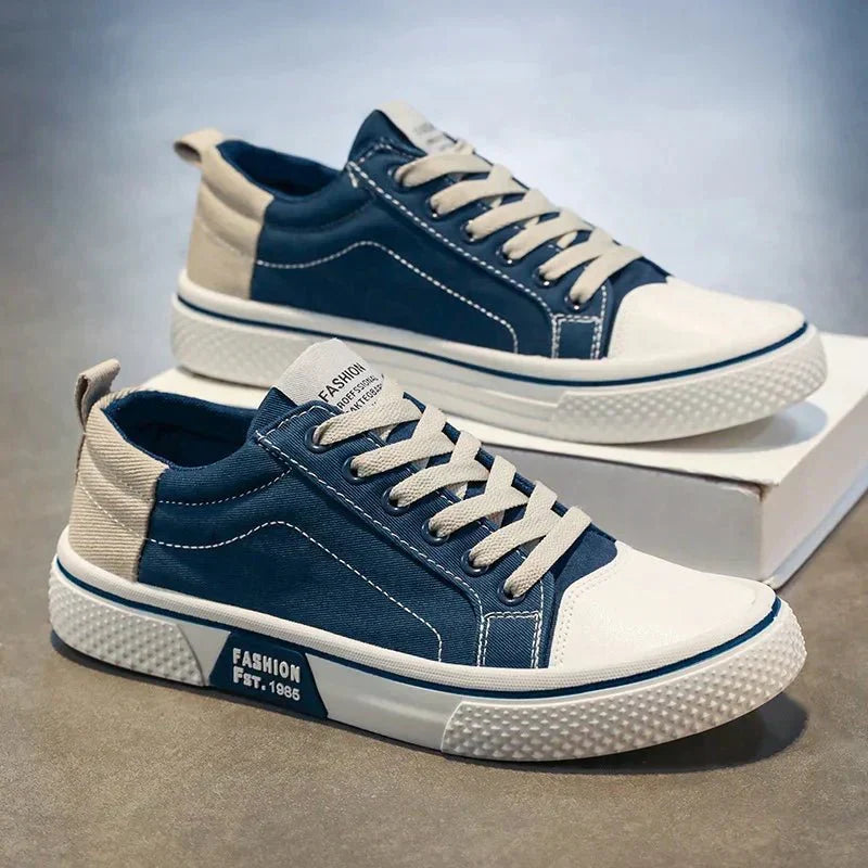 Low-top lace-up trainers shown in blue and green colourways with round toes and contrast soles