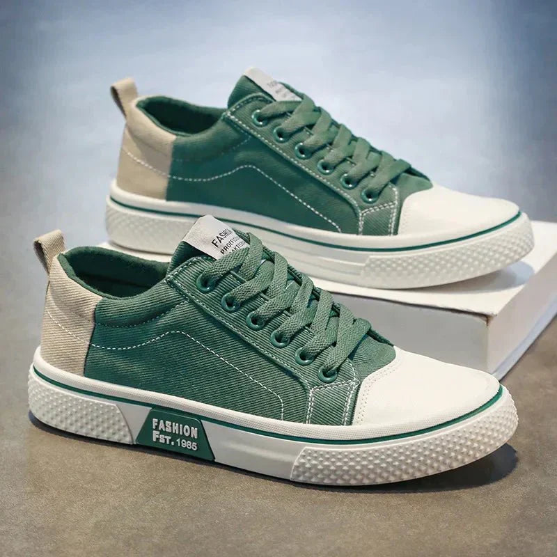 Low-top lace-up trainers shown in blue and green colourways with round toes and contrast soles